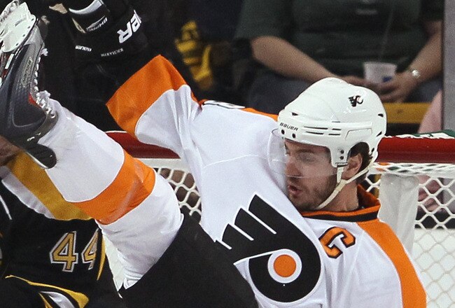 BOSTON, MA - MAY 06: Tim Thomas #30 of the Boston Bruins stops a shot as Mike Richards #18 of the Philadelphia Flyers falls in Game Four of the Eastern Conference Semifinals during the 2011 NHL Stanley Cup Playoffs at TD Garden on May 6, 2011 in Boston, Massachusetts.  (Photo by Elsa/Getty Images)