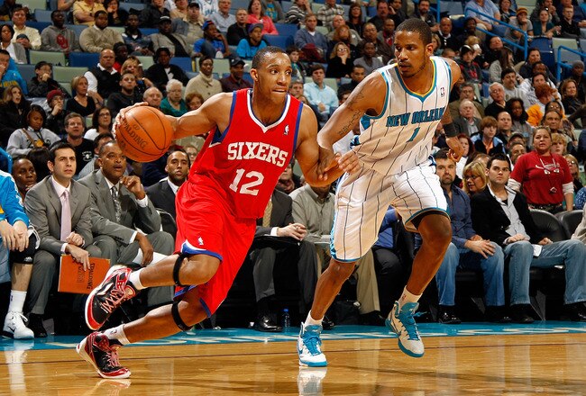 NEW ORLEANS, LA - JANUARY 03:  Evan Turner #12 of the Philadelphia 76ers drives on Trevor Ariza #1 of the New Orleans Hornets in the second half at New Orleans Arena on January 3, 2011 in New Orleans, Louisiana. NOTE TO USER: User expressly acknowledges and agrees that, by downloading and/or using this photograph, User is consenting to the terms and conditions of the Getty Images License Agreement.  (Photo by Chris Graythen/Getty Images)