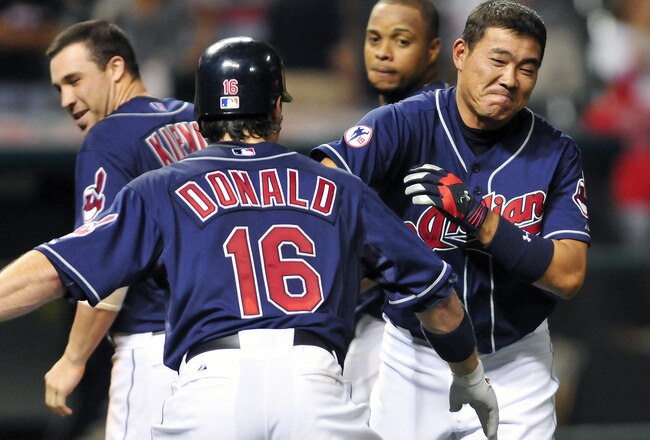 CLEVELAND, OH - AUGUST 10: Jason Donald #16 celebrates with Kosuke Fukudome #1 of the Cleveland Indians after Fukadome was hit by a pitch with the bases loaded to score the winning run to defeat the Detroit Tigers 3-2 in the fourteenth inning at Progressive Field on August 10, 2011 in Cleveland, Ohio. (Photo by Jason Miller/Getty Images)