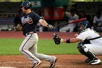 MIAMI GARDENS, FL - AUGUST 08:  Dan Uggla #26 of the Atlanta Braves gets a hit in the fifth inning against the Florida Marlins at Sun Life Stadium on August 8, 2011 in Miami Gardens, Florida.  (Photo by Marc Serota/Getty Images)