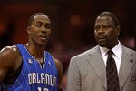 CLEVELAND - MAY 28: Dwight Howard #12 and assistant coach Patrick Ewing of the Orlando Magic talk on the sideline against the Cleveland Cavaliers in Game Five of the Eastern Conference Finals during the 2009 Playoffs at Quicken Loans Arena on May 28, 2009 in Cleveland, Ohio. NOTE TO USER: User expressly acknowledges and agrees that, by downloading and or using this photograph, User is consenting to the terms and conditions of the Getty Images License Agreement  (Photo by Elsa/Getty Images)