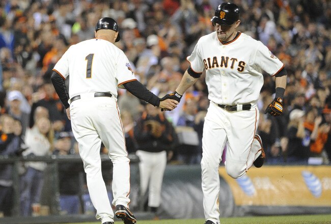 SAN FRANCISCO, CA - AUGUST 9: Aubrey Huff #17 of the San Francisco Giants rounds the bases and shakes hands with Tim Flannery #1 after hitting a home run off of James McDonald #53 of the Pittsburgh Pirates in the six inning during an MLB baseball game at AT&T Park August 9, 2011 in San Francisco, California. (Photo by Thearon W. Henderson/Getty Images)