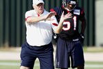 HOUSTON, TX - AUGUST 01:  Defensive Coordinator Wade Phillips of the Houston Texans goes over plays with inside linebacker Darryl Sharpton #51 during practice on the first day of training camp at Reliant Park on August 1, 2011 in Houston, Texas.  (Photo by Bob Levey/Getty Images)