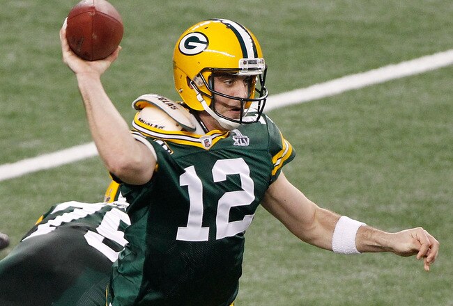 ARLINGTON, TX - FEBRUARY 06:  Aaron Rodgers #12 of the Green Bay Packers drops back against the Pittsburgh Steelers in the second quarter of Super Bowl XLV at Cowboys Stadium on February 6, 2011 in Arlington, Texas.  (Photo by Joe Robbins/Getty Images)
