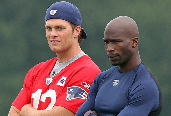 FOXBOROUGH, MA  - JULY 29:  Tom Brady #12 and Chad Ochocinco of the New England Patriots chat during training camp at Gillette Stadium on July 29, 2011 in Foxborough, Massachusetts.  (Photo by Jim Rogash/Getty Images)
