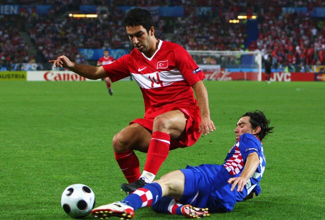 VIENNA, AUSTRIA - JUNE 20:  Arda Turan of Turkey battles for the ball with Danijel Pranjic of Croatia during the UEFA EURO 2008 Quarter Final match between Croatia and Turkey at Ernst Happel Stadion on June 20, 2008 in Vienna, Austria.  (Photo by Jamie McDonald/Getty Images)