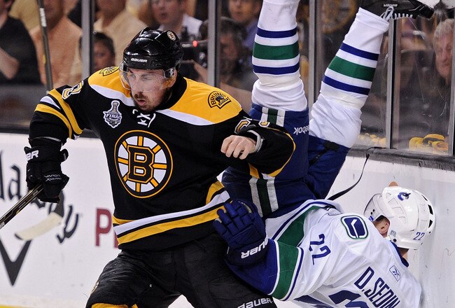 BOSTON, MA - JUNE 08:  Brad Marchand #63 of the Boston Bruins dodges Daniel Sedin #22 of the Vancouver Canucks during Game Four of the 2011 NHL Stanley Cup Final at TD Garden on June 8, 2011 in Boston, Massachusetts.  (Photo by Harry How/Getty Images)
