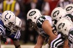 INDIANAPOLIS, IN - JANUARY 08:  Center Nick Mangold #74 of the New York Jets readies the ball for the snap against Fili Moalo #95 of the Indianapolis Colts during their 2011 AFC wild card playoff game at Lucas Oil Stadium on January 8, 2011 in Indianapolis, Indiana. The Jets won 17-16. (Photo by Jonathan Daniel/Getty Images)