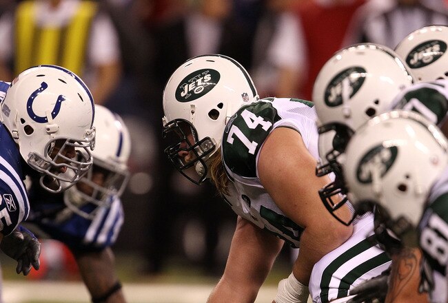 INDIANAPOLIS, IN - JANUARY 08:  Center Nick Mangold #74 of the New York Jets readies the ball for the snap against Fili Moalo #95 of the Indianapolis Colts during their 2011 AFC wild card playoff game at Lucas Oil Stadium on January 8, 2011 in Indianapolis, Indiana. The Jets won 17-16. (Photo by Jonathan Daniel/Getty Images)