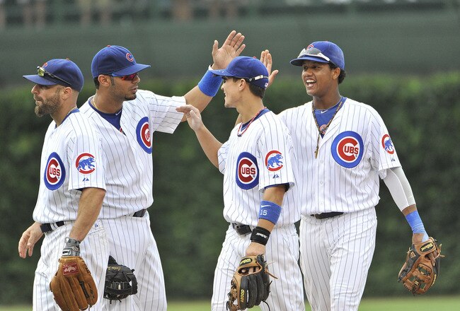 CHICAGO, IL - AUGUST 06:  Reed Johnson #5, Carlos Pena #22, Darwin Barney #15 and Starlin Castro #13 of the Chicago Cubs celebrate their 11-4 win over the Cincinnati Reds at Wrigley Field on August 6, 2011 in Chicago, Illinois.  (Photo by Brian Kersey/Getty Images)