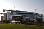 HOUSTON, TX - AUGUST 01:  Grounds crew prepare the practice field for the first day  of Houston Texans training camp at Reliant Park as Reliant Stadium is visible in the background on August 1, 2011 in Houston, Texas.  (Photo by Bob Levey/Getty Images)