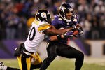 BALTIMORE, MD - DECEMBER 05:  T.J. Houshmandzadeh #84 of the Baltimore Ravens runs the ball against Bryant McFadden #20 of the Pittsburgh Steelers during the first half of the game at M&T Bank Stadium on December 5, 2010 in Baltimore, Maryland. Pittsburgh won 13-10.  (Photo by Larry French/Getty Images)