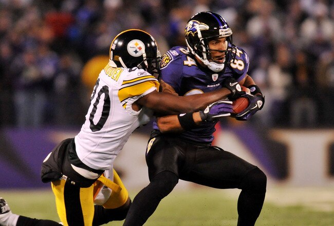 BALTIMORE, MD - DECEMBER 05:  T.J. Houshmandzadeh #84 of the Baltimore Ravens runs the ball against Bryant McFadden #20 of the Pittsburgh Steelers during the first half of the game at M&T Bank Stadium on December 5, 2010 in Baltimore, Maryland. Pittsburgh won 13-10.  (Photo by Larry French/Getty Images)