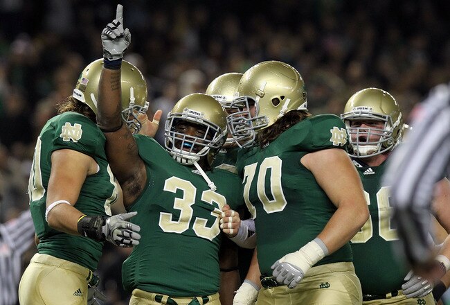 NEW YORK - NOVEMBER 20: Robert Hughes #33 of the Notre Dame Fighting Irish celebrates his touchdown with teammates agianst the Army Black Knights at Yankee Stadium on November 20, 2010 in the Bronx borough of New York City.  (Photo by Nick Laham/Getty Images)