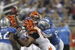 DETROIT - AUGUST 12: Ndamukong Suh #90 of the Detroit Lions hits quarterback Andy Dalton #14 of the Cincinnati Bengals in the second quarter and is called for a roughing the passer penalty during the game at Ford Field on August 12, 2011 in Detroit, Michigan.  (Photo by Leon Halip/Getty Images)