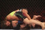 PHOENIX - AUGUST 13:  Miesha Tate (top) battles with Hitomi Akano of Japan in the Strikeforce Women's Welterweight Tournament Championship bout at Dodge Theater on August 13, 2010 in Phoenix, Arizona.  (Photo by Christian Petersen/Getty Images)