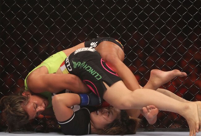 PHOENIX - AUGUST 13:  Miesha Tate (top) battles with Hitomi Akano of Japan in the Strikeforce Women's Welterweight Tournament Championship bout at Dodge Theater on August 13, 2010 in Phoenix, Arizona.  (Photo by Christian Petersen/Getty Images)