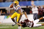 ARLINGTON, TX - JANUARY 07:  Stevan Ridley #34 of the Louisiana State University Tigers avoids a tackle by Dustin Harris #22 of the Texas A&M Aggies during the AT&T Cotton Bowl at Cowboys Stadium on January 7, 2011 in Arlington, Texas.  (Photo by Chris Graythen/Getty Images)