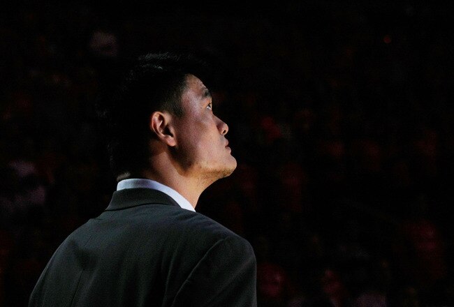 HOUSTON - APRIL 19:  Injured center Yao Ming #11 of the Houston Rockets watches pregame introductions for Game One of the Western Conference Quarterfinals against the Utah Jazz during the 2008 NBA Playoffs at the Toyota Center on April 19, 2008 in Houston, Texas. The Jazz won 93-82.  NOTE TO USER: User expressly acknowledges and agrees that, by downloading and or using this photograph, User is consenting to the terms and conditions of the Getty Images License Agreement.  (Photo by Stephen Dunn/Getty Images)