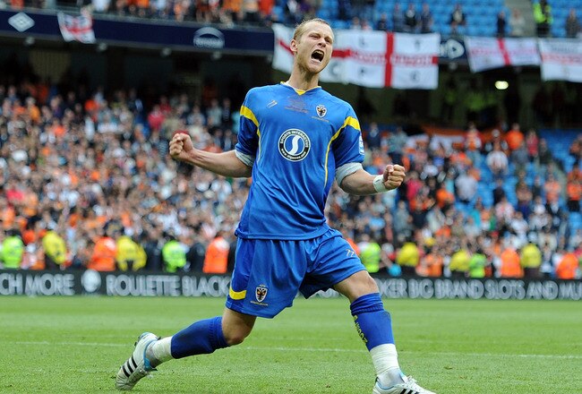 MANCHESTER, ENGLAND - MAY 21:  Seb Hatton of AFC Wimbledon celebrates scoring a penalty in the shoot out during the Blue Square Bet Premier League Play Off Final between AFC Wimbledon and Luton Town at City of Manchester Stadium on May 21, 2011 in Manchester, England.  (Photo by Chris Brunskill/Getty Images)