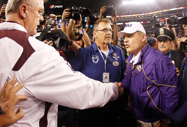 ARLINGTON, TX - JANUARY 07:  Head coach Les Miles of the Louisiana State University Tigers is congratulated by head coach Mike Sherman of the Texas A&M Aggies after the AT&T Cotton Bowl at Cowboys Stadium on January 7, 2011 in Arlington, Texas.  The Tigers defeated the Aggies 41-24.  (Photo by Chris Graythen/Getty Images)