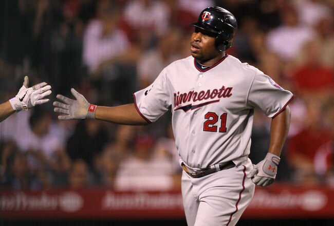 ANAHEIM, CA - AUGUST 03:  Delmon Young #21 of the Minnesota Twins is greeted after hitting his second home run of the game, in the fourth inning against the Los Angeles Angels of Anaheim on August 3, 2011 at Angel Stadium in Anaheim, California.  (Photo by Stephen Dunn/Getty Images)