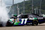 WATKINS GLEN, NY - AUGUST 15:  Denny Hamlin crashes the #11 FedEx Ground Toyota into the tire barrier after an incident in the NASCAR Sprint Cup Series Heluva Good! Sour Cream Dips at the Glen at Watkins Glen International on August 15, 2011 in Watkins Glen, New York.  (Photo by Jeff Zelevansky/Getty Images for NASCAR)