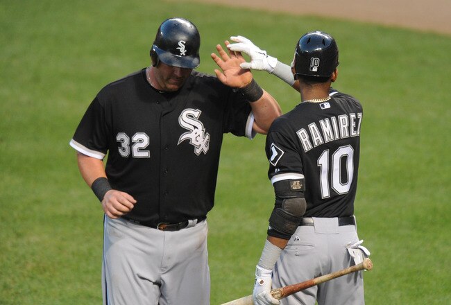 BALTIMORE, MD - AUGUST 11:  Adam Dunn #32 of the Chicago White Sox celebrates scoring a run with Alexei Ramirez #10 during the third inning of a baseball game against the Baltimore Orioles at Oriole Park at Camden Yards on August 11, 2011 in Baltimore, Maryland.  The White SOx won 6-3.  (Photo by Mitchell Layton/Getty Images)