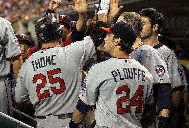 DETROIT, MI - AUGUST 15:  DH, Jim Thome #25 of the Minnesota Twins high-fives teammates in the dug-out after hitting his first home run against the Detroit Tigers during a MLB game at Comerica Park on August 15, 2011 in Detroit, Michigan.  The Twins won 9-6  (Photo by Dave Reginek/Getty Images)