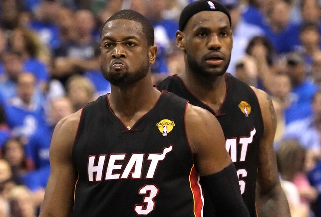 DALLAS, TX - JUNE 09:  Dwyane Wade #3 and LeBron James #6 of the Miami Heat look on in the fourth quarter against the Dallas Mavericks in Game Five of the 2011 NBA Finals at American Airlines Center on June 9, 2011 in Dallas, Texas.  NOTE TO USER: User expressly acknowledges and agrees that, by downloading and/or using this Photograph, user is consenting to the terms and conditions of the Getty Images License Agreement.  (Photo by Ronald Martinez/Getty Images)