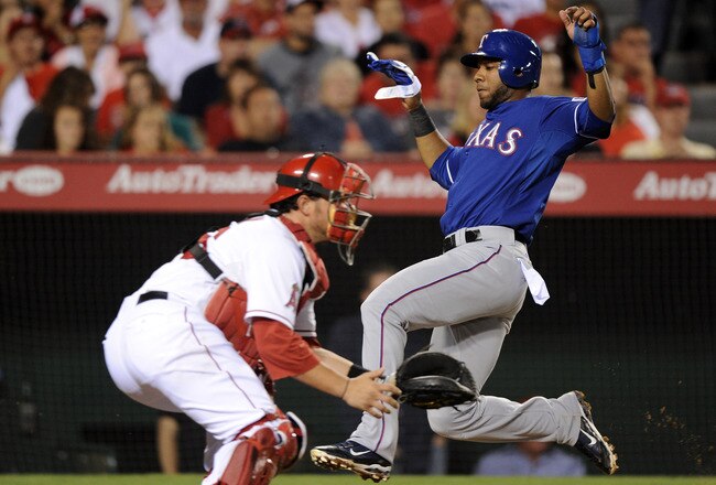 ANAHEIM, CA - AUGUST 15:  Elvis Andrus #1 of the Texas Rangers slides in ahead of a tag from Bobby Wilson #46 of the Los Angeles Angels of Anaheim during the fifth inning at Angel Stadium of Anaheim on August 15, 2011 in Anaheim, California.  (Photo by Harry How/Getty Images)