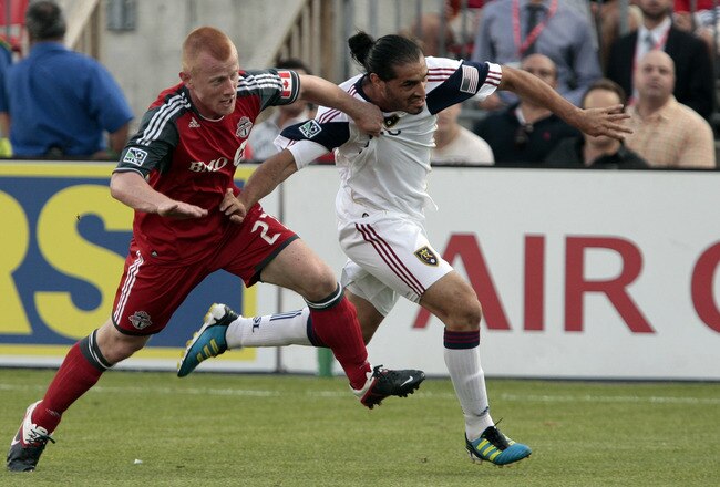 TORONTO, CANADA - AUGUST 13:  Richard Eckersley #27 of Toronto FC runs into Fabian Espindola #7 of Real Salt Lake during MLS action at  BMO Field August 13, 2011 in Toronto, Ontario, Canada. (Photo by Abelimages/Getty Images)