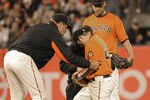 SAN FRANCISCO, CA - JUNE 10: Manager Bruce Bochy (L) of the San Francisco Giants helps injured second baseman Freddy Sanchez #21 up and off the field as Pat Burrell #5 looks on against the Cincinnati Reds during a MLB baseball game June 10, 2011 at AT&T Park in San Francisco, California. (Photo by Thearon W. Henderson/Getty Images)
