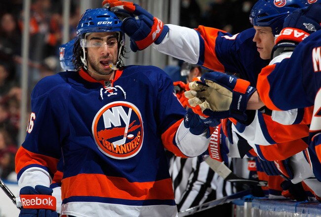 UNIONDALE, NY - FEBRUARY 21:  Matt Moulson #26 of the New York Islanders is congratulated by teammates on the bench after scoring an empty net goal for a hat trick late in the third period of an NHL hockey game against the Florida Panthers at the Nassau Coliseum on February 21, 2011 in Uniondale, New York. Islanders won 5-1. (Photo by Paul Bereswill/Getty Images)