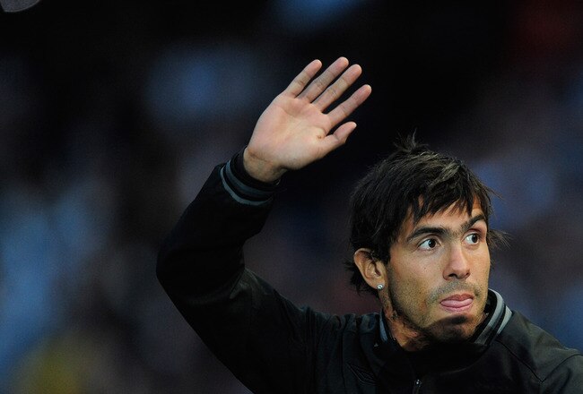 MANCHESTER, ENGLAND - MAY 23:  Carlos Tevez of Manchester City waves to the fans during the Manchester City FA Cup Winners Parade at the City of Manchester stadium on May 23, 2011 in Manchester, United Kingdom.  (Photo by Jamie McDonald/Getty Images)