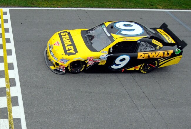 MONTREAL, QC - AUGUST 20:  Marcos Ambrose, driver of the #9 Stanley Ford, crosses the finish line to win the NASCAR Nationwide Series NAPA Auto Parts 200 at Circuit Gilles Villeneuve on August 20, 2011 in Montreal, Canada. (Photo by Jason Smith/Getty Images)