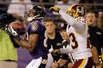 BALTIMORE, MD - AUGUST 25: Wide receiver Lee Evans #83 of the Baltimore Ravens catches a touchdown pass against defender DeAngelo Hall #23 of the Washington Redskins during the first half of a preason game at M&T Bank Stadium on August 25, 2011 in Baltimore, Maryland.  (Photo by Rob Carr/Getty Images)