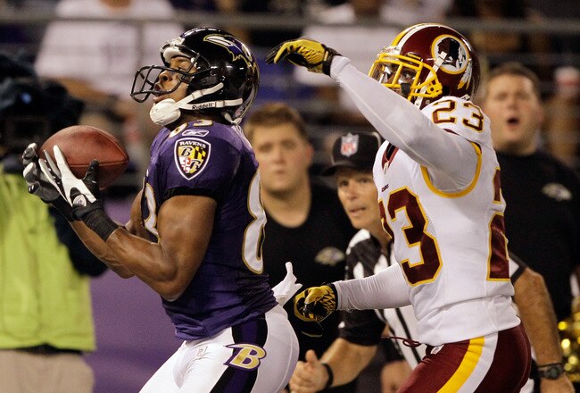 BALTIMORE, MD - AUGUST 25: Wide receiver Lee Evans #83 of the Baltimore Ravens catches a touchdown pass against defender DeAngelo Hall #23 of the Washington Redskins during the first half of a preason game at M&T Bank Stadium on August 25, 2011 in Baltimore, Maryland.  (Photo by Rob Carr/Getty Images)