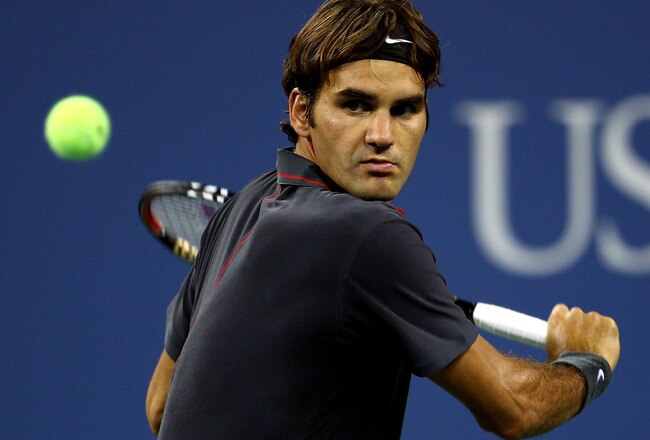 NEW YORK, NY - AUGUST 29:  Roger Federer of  Switzerland returns the ball against Santiago Giraldo of Colombia during Day One of the 2011 US Open at the USTA Billie Jean King National Tennis Center on August 29, 2011 in the Flushing neighborhood of the Queens borough of New York City.  (Photo by Julian Finney/Getty Images)