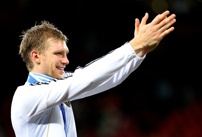 PORT ELIZABETH, SOUTH AFRICA - JULY 10:  Per Mertesacker of Germany celebrates victory and third place following the 2010 FIFA World Cup South Africa Third Place Play-off match between Uruguay and Germany at The Nelson Mandela Bay Stadium on July 10, 2010 in Port Elizabeth, South Africa.  (Photo by Doug Pensinger/Getty Images)