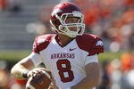 AUBURN, AL - OCTOBER 16:  Quarterback Tyler Wilson #8 of the Arkansas Razorbacks drops back and looks downfield before the game against the Auburn Tigers at Jordan-Hare Stadium on October 16, 2010 in Auburn, Alabama.  The Tigers beat the Razorbacks 65-43.  (Photo by Mike Zarrilli/Getty Images)