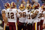 BALTIMORE, MD - AUGUST 25: Quarterback John Beck #12 of the Washington Redskins talks with the offense before the start of a preseason game against the Baltimore Ravens at M&T Bank Stadium on August 25, 2011 in Baltimore, Maryland.  (Photo by Rob Carr/Getty Images)