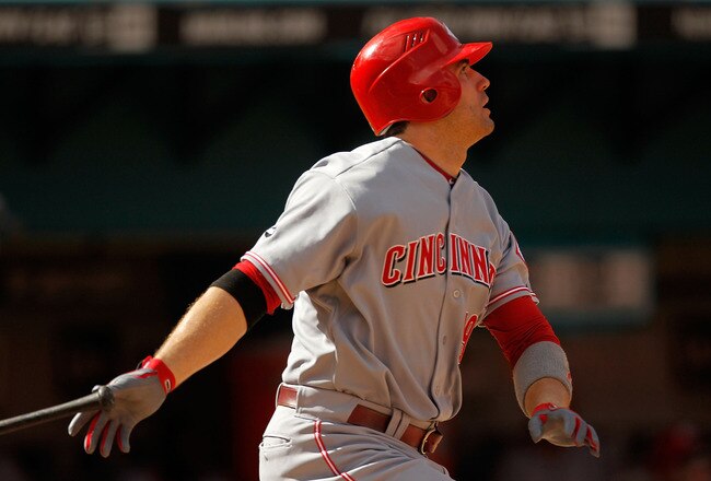 MIAMI GARDENS, FL - AUGUST 24: Joey Votto #19 of the Cincinnati Reds hits a two run home run during game one of a doubleheader against the Florida Marlins at Sun Life Stadium on August 24, 2011 in Miami Gardens, Florida.  (Photo by Mike Ehrmann/Getty Images)