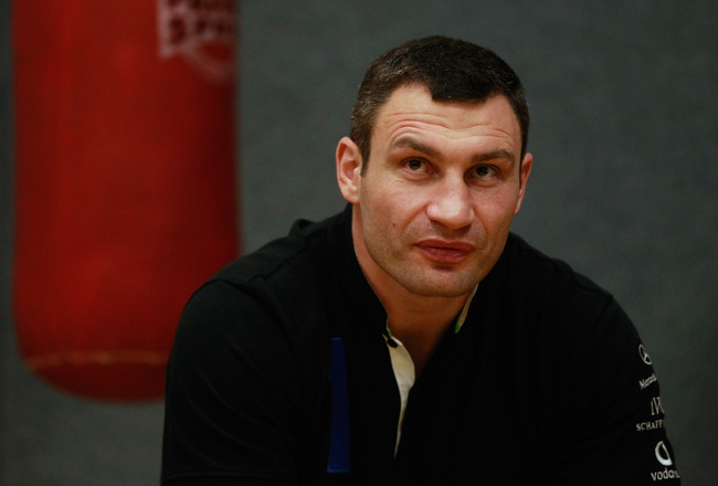 BERLIN - NOVEMBER 16:  Pro boxer Vitali Klitschko sits prior to coaching young boxers at the 'Kick im Boxring' at the TC Gruen Weiss boxing hall in Treptow district on November 16, 2010 in Berlin, Germany. The 'Kick im Boxring' project encourages youth in troubled Berlin city districts to get into boxing. The event was part of the Laureus World Sports Academy Forum.  (Photo by Sean Gallup/Getty Images)