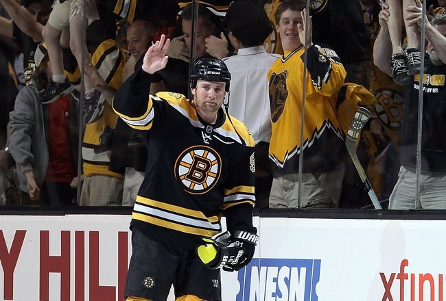 BOSTON - MAY 01:  Marc Savard #91 of the Boston Bruins salutes the cheering fans after the game against the Philadelphia Flyers in Game One of the Eastern Conference Semifinals during the 2010 NHL Stanley Cup Playoffs at TD Garden on May 1, 2010 in Boston, Massachusetts. The Bruins defeated the Flyers 5-4 in overtime.  (Photo by Elsa/Getty Images)