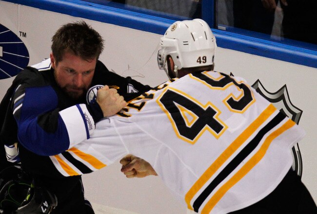 TAMPA, FL - MAY 21:  Rich Peverley #49 of the Boston Bruins fights Marc-Andre Bergeron #47 of the Tampa Bay Lightning in Game Four of the Eastern Conference Finals during the 2011 NHL Stanley Cup Playoffs at St Pete Times Forum on May 21, 2011 in Tampa, Florida.  (Photo by Eliot J. Schechter/Getty Images)