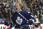 TORONTO - JANUARY 1:  Wade Belak #3 of the Toronto Maple Leafs celebrates a goal scored by teammate Kris Newbury against the Boston Bruins during their NHL game at the Air Canada Centre January 1, 2007 in Toronto, Ontario.  (Photo by Dave Sandford/Getty Images)