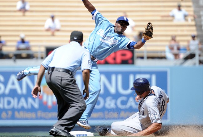 LOS ANGELES, CA - AUGUST 31:  Eugenio Velez #3 of the Los Angeles Dodgers can't make a catch as Kyle Blanks #88 of the San Diego Padres steals second base during the sixth inning at Dodger Stadium on August 31, 2011 in Los Angeles, California.  (Photo by Harry How/Getty Images)