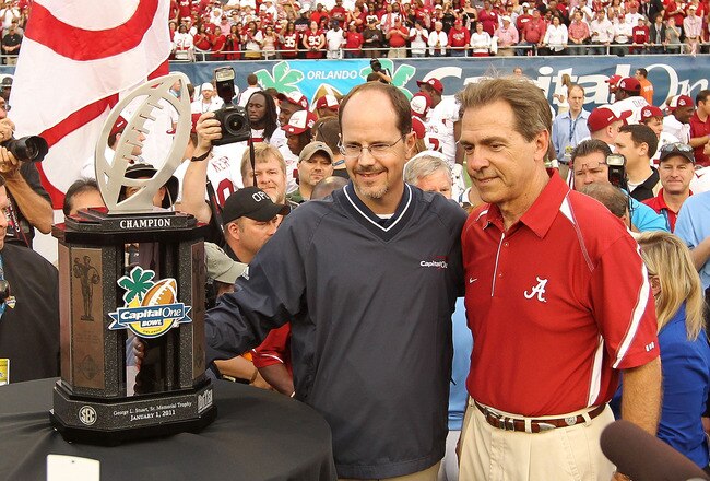 ORLANDO, FL - JANUARY 01:  Alabama Crimson Tide Head Coach Nick Saban is presented the trophy for winning the Capitol One Bowl against the Michigan State Spartans at the Florida Citrus Bowl on January 1, 2011 in Orlando, Florida.  (Photo by Mike Ehrmann/Getty Images)