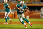 MIAMI GARDENS, FL - SEPTEMBER 01:   Daniel Thomas #33 of the Miami Dolphins runs with the ball during a Pre-Season NFL game against the Dallas Cowboys at Sun Life Stadium on September 1, 2011 in Miami Gardens, Florida.  (Photo by Mike Ehrmann/Getty Images)